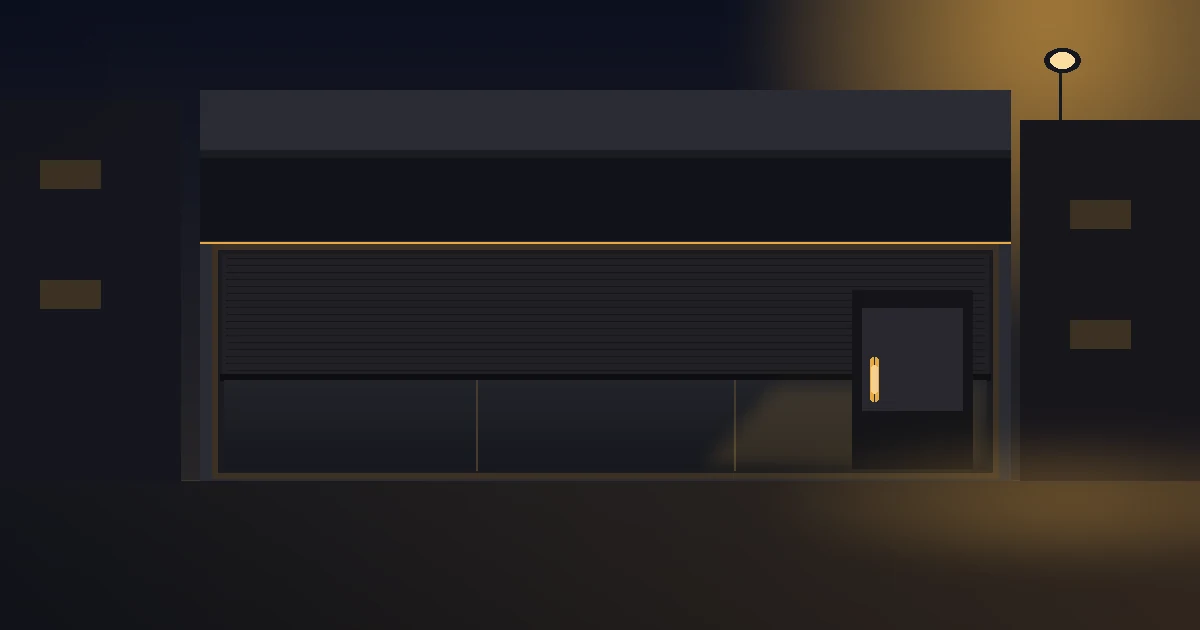 Locked empty high-street retail unit at dusk, shutter half down, brass door handle catching warm amber light from a streetlamp